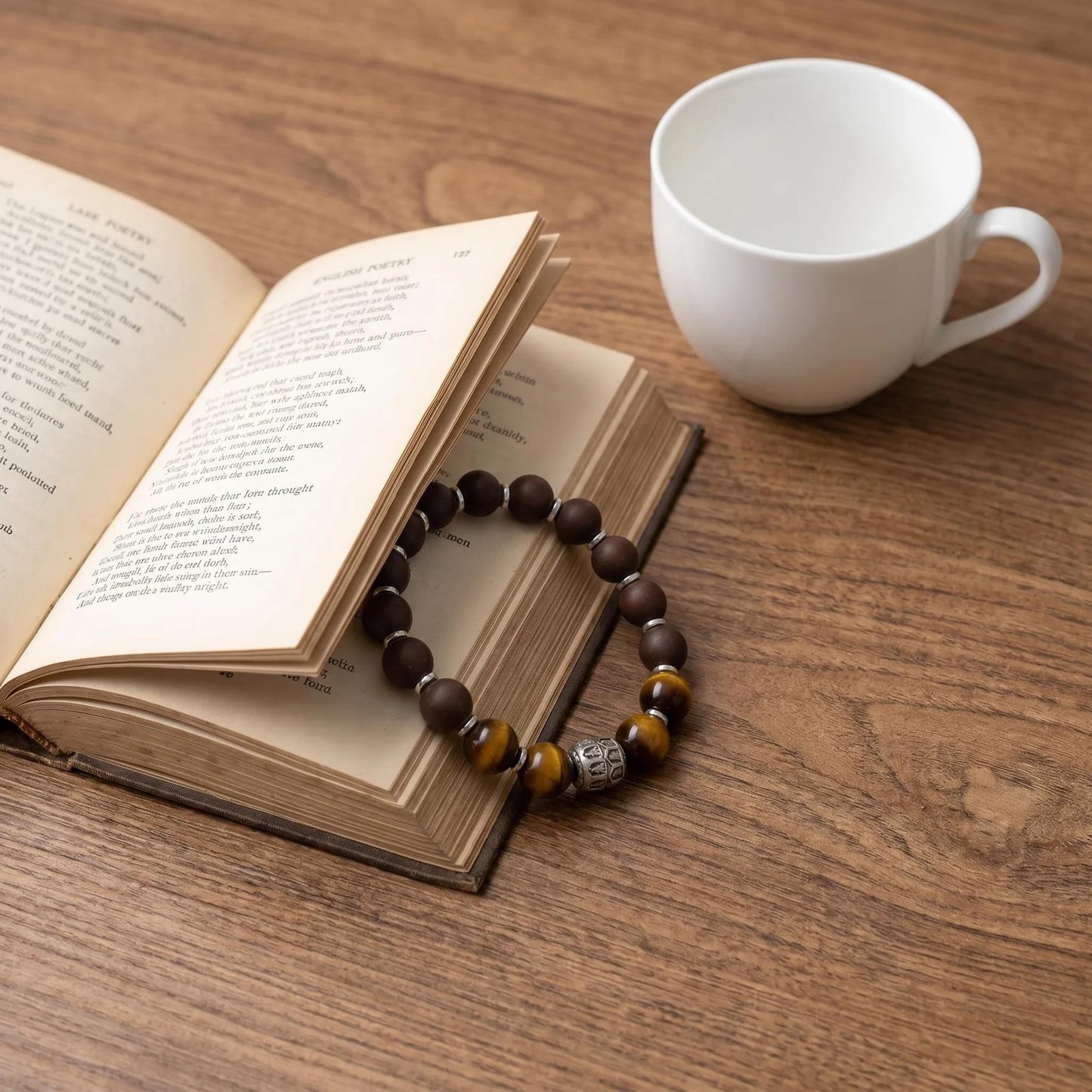 PEAR BLOSSOM wearable incense bracelet placed beside a book and cup for a quiet gifting scene.