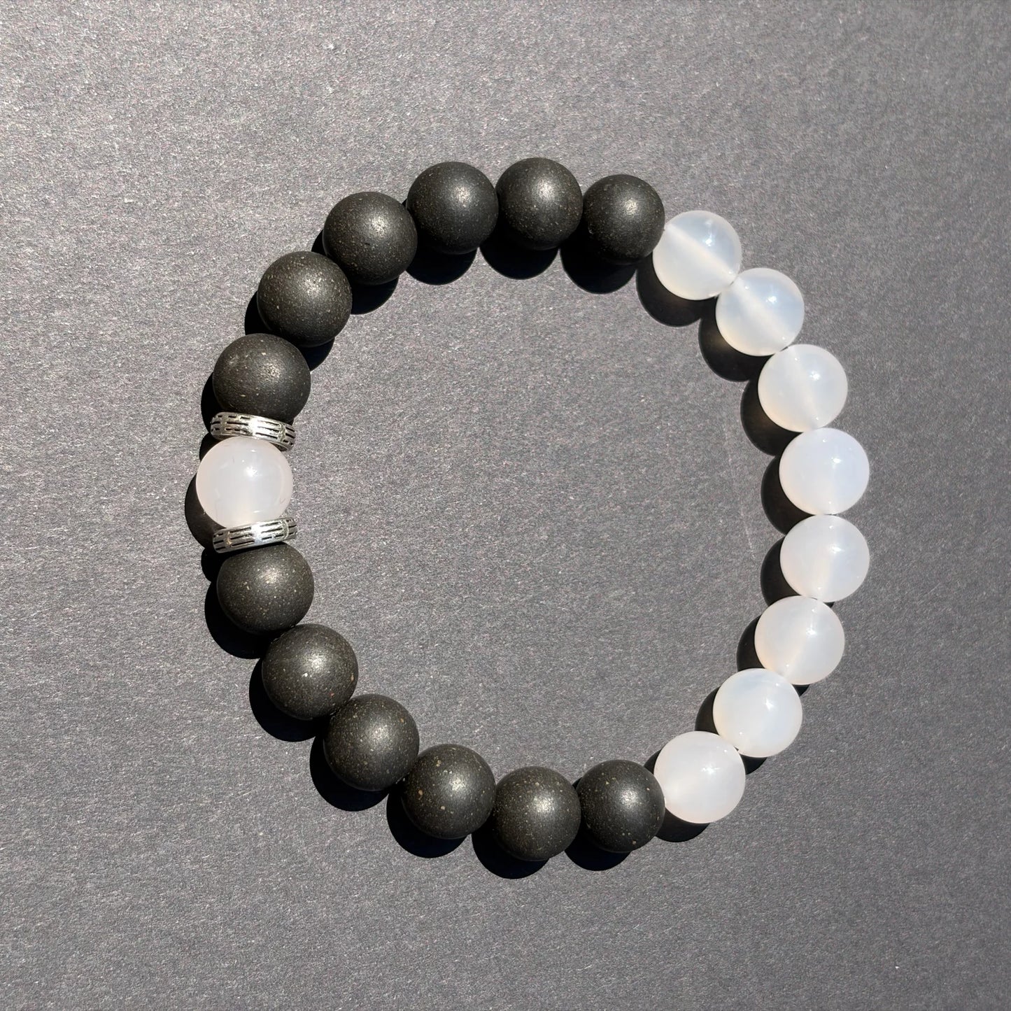 SKIN BREATH wearable incense bracelet shown from above with black and white bead balance.