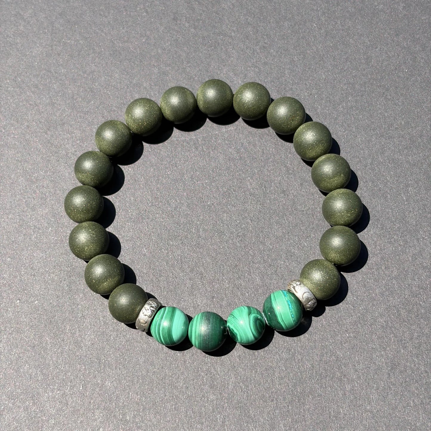 EAST PAVILION wearable incense bracelet shown from above with green accent beads.