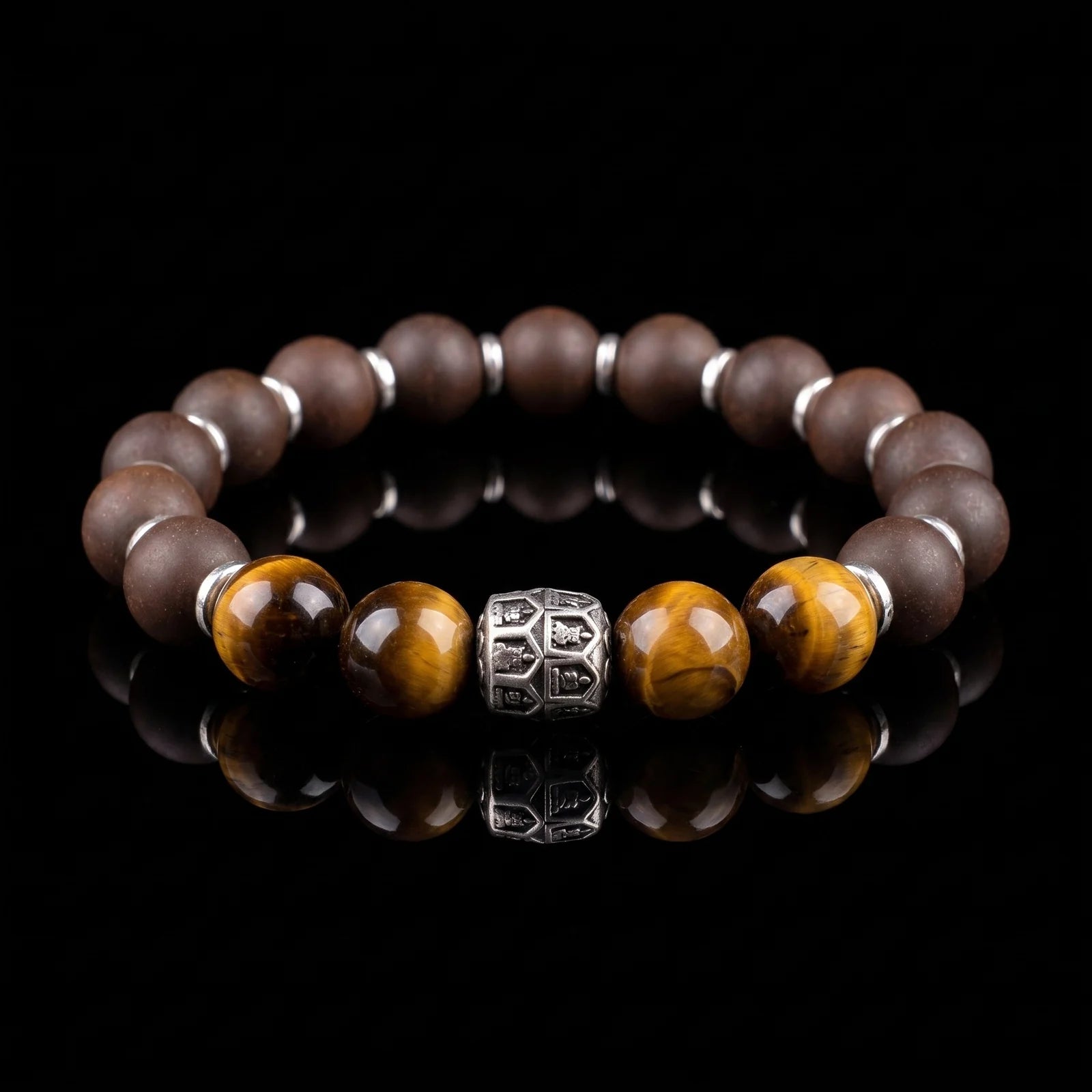 PEAR BLOSSOM Still Mind wearable incense bracelet with brown beads and tiger eye accents on a black reflective surface.