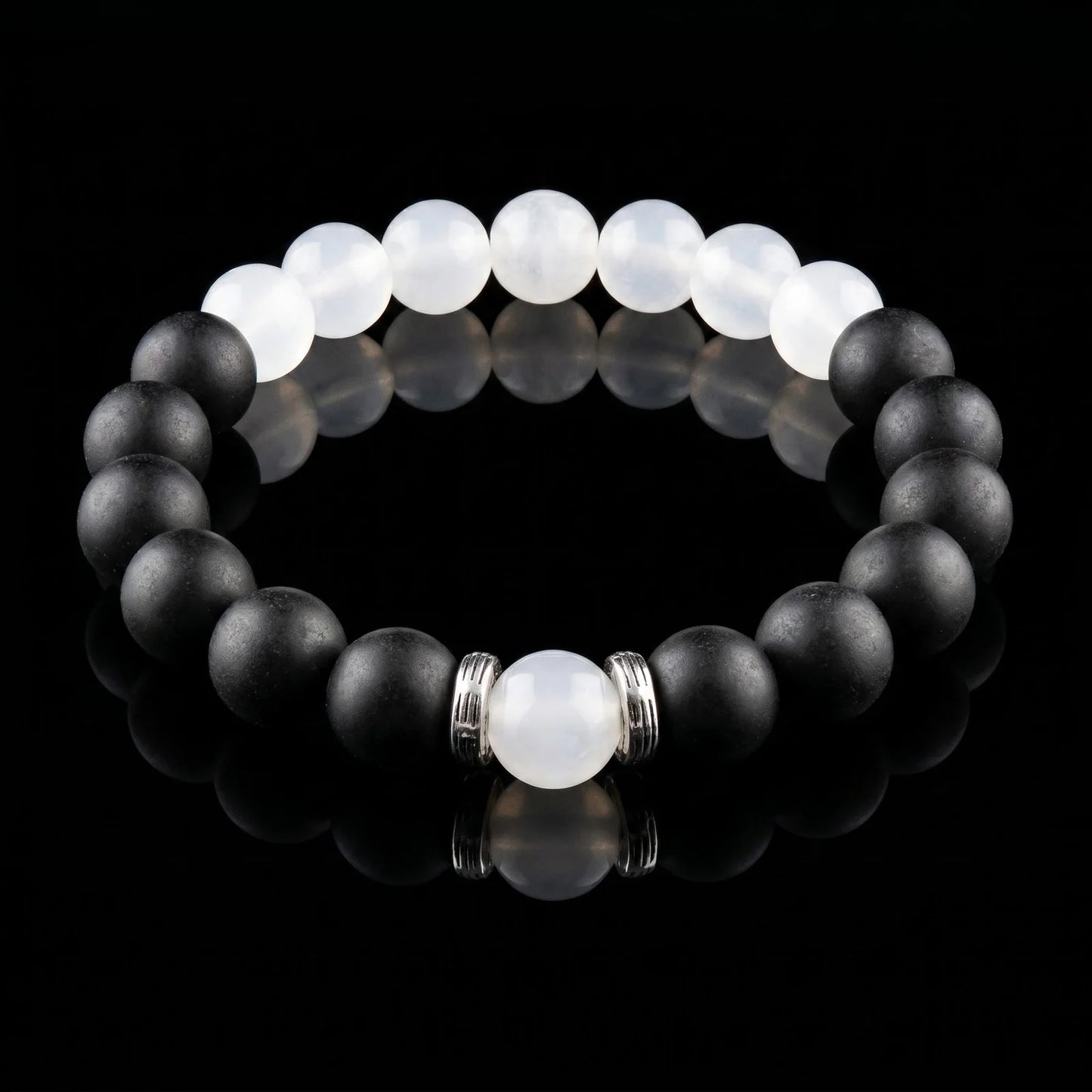 SKIN BREATH Still Mind wearable incense bracelet with black and white beads on a black reflective surface.