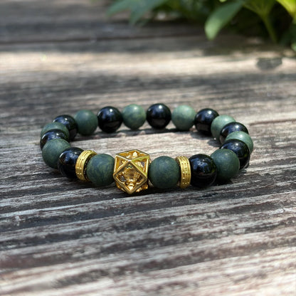 AZURE DRAGON green and black aromatic bead bracelet placed on weathered wood with natural light.