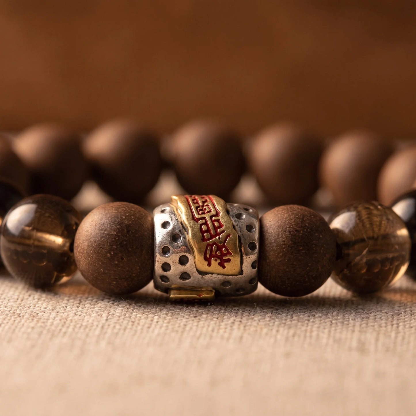 WARM YANG bracelet close-up showing the central Tibetan-style spacer and warm brown beads.