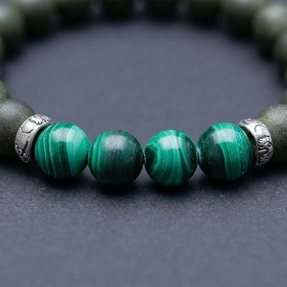 EAST PAVILION bracelet close-up showing green malachite-style beads and silver-toned spacer details.