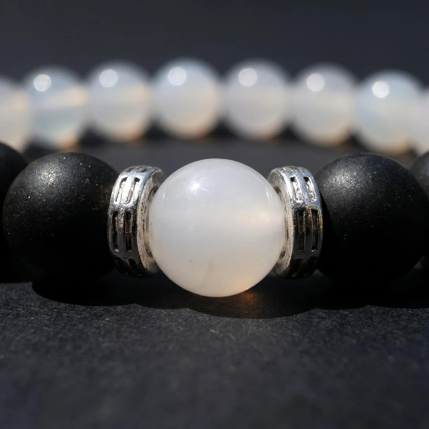 SKIN BREATH bracelet macro image showing the white center bead and silver-toned spacer details.