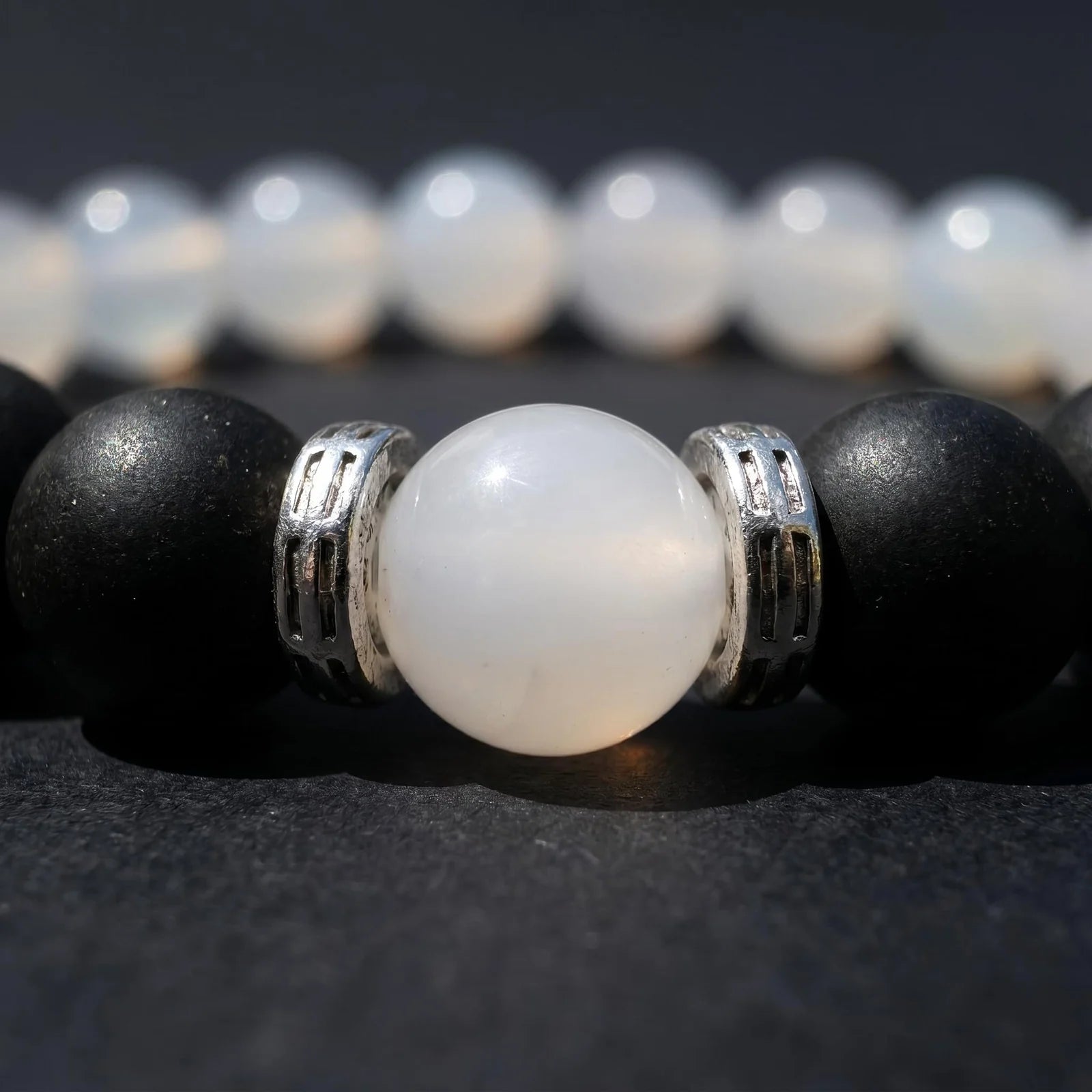 SKIN BREATH bracelet macro image showing the white center bead and silver-toned spacer details.