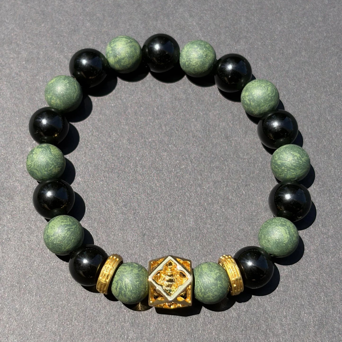 AZURE DRAGON wearable incense bracelet shown from above with green aromatic beads and black obsidian beads.