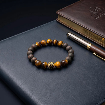 BLACK ACCORD aromatic bead bracelet on a leather desk with a pen and notebook for a business setting.