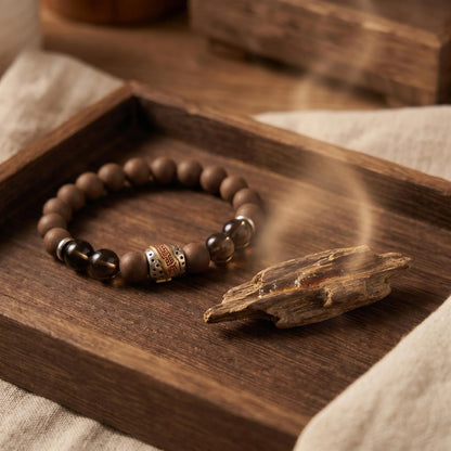 WARM YANG wearable incense bracelet shown with wood and soft incense atmosphere.
