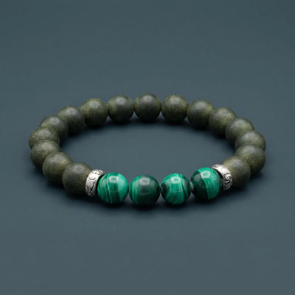 EAST PAVILION wearable incense bracelet shown on a wrist in a quiet table setting.