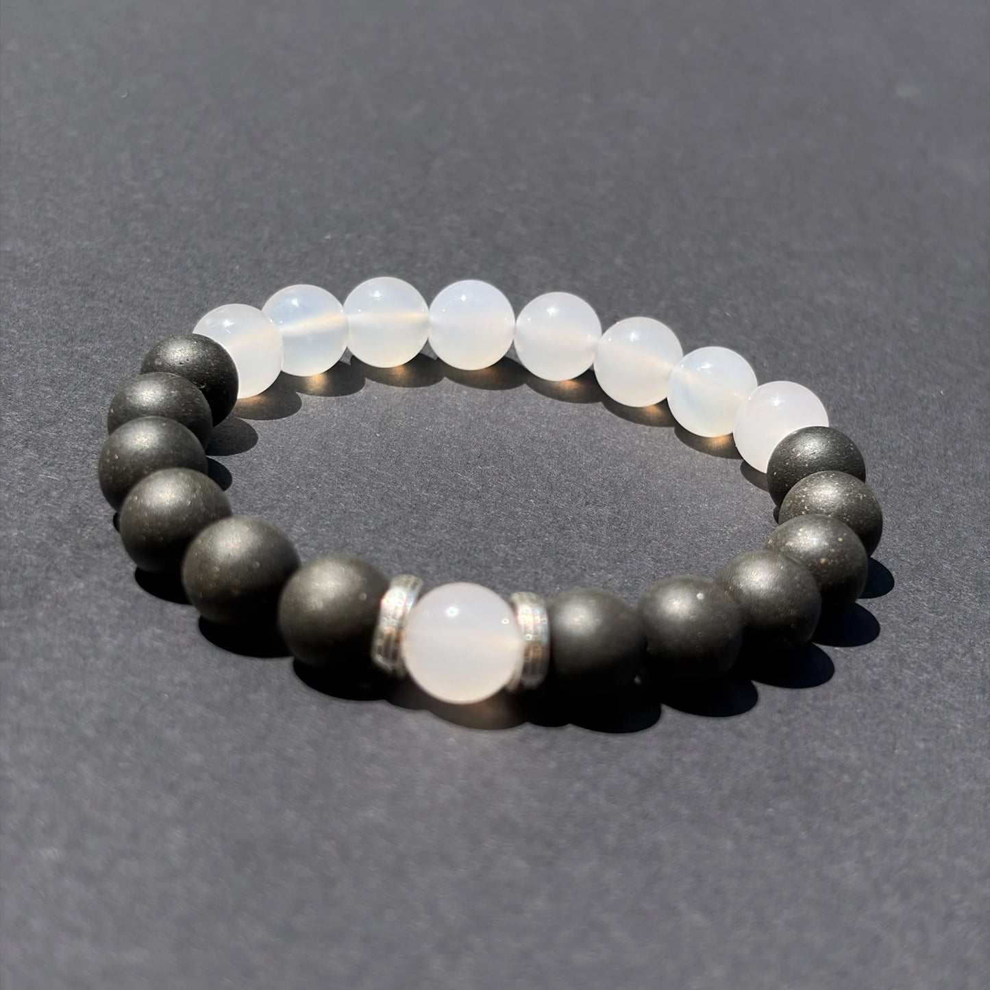 SKIN BREATH wearable incense bracelet shown from an angled view on a clean gray surface.
