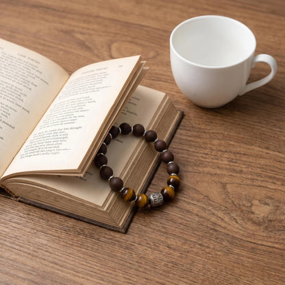PEAR BLOSSOM wearable incense bracelet placed beside a book and cup for a quiet gifting scene.