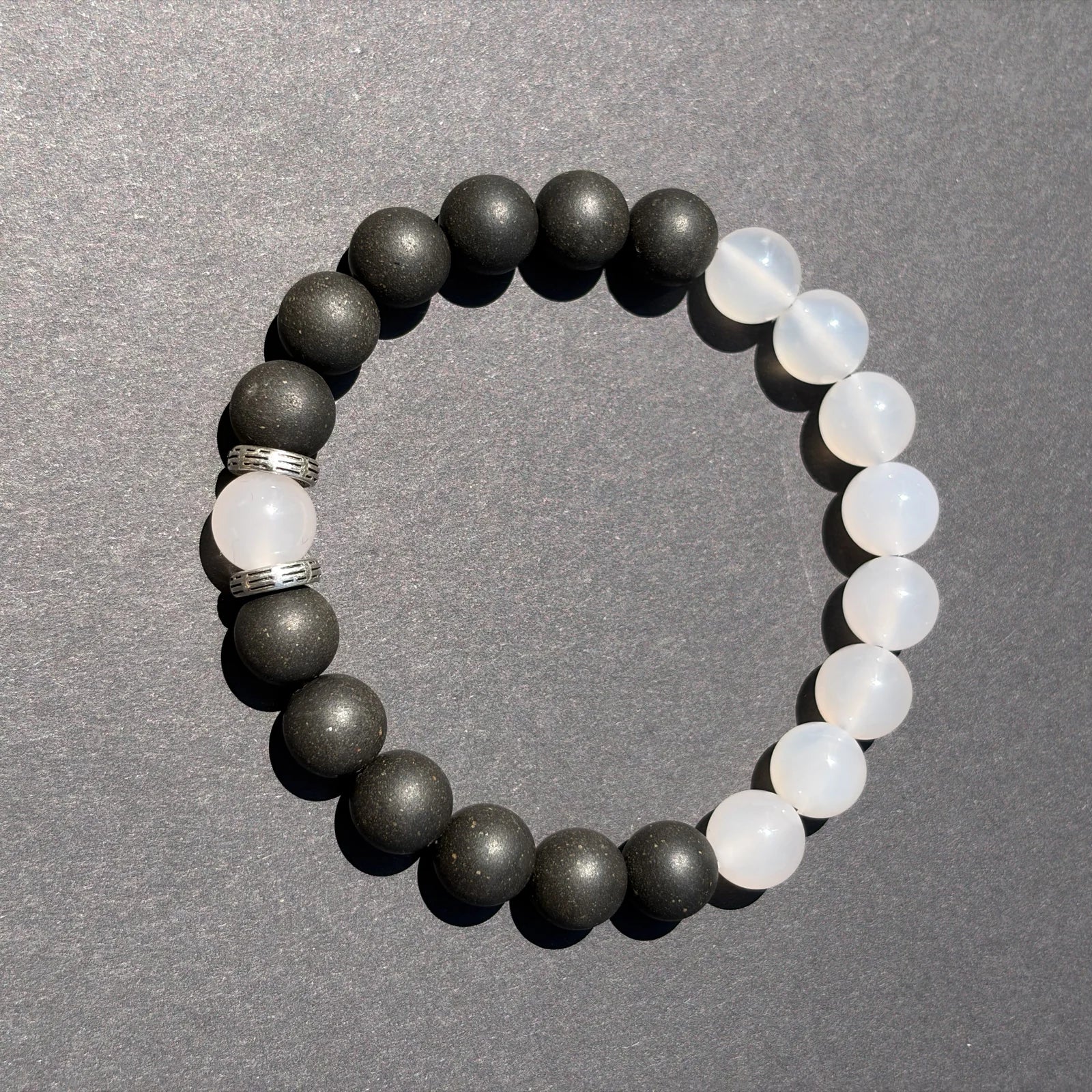 SKIN BREATH wearable incense bracelet shown from above with black and white bead balance.
