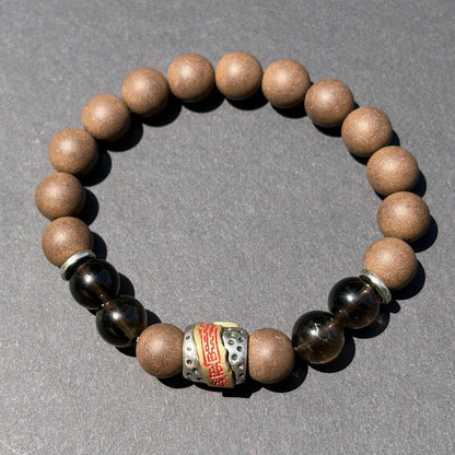WARM YANG wearable incense bracelet shown from above with brown beads and dark accent beads.