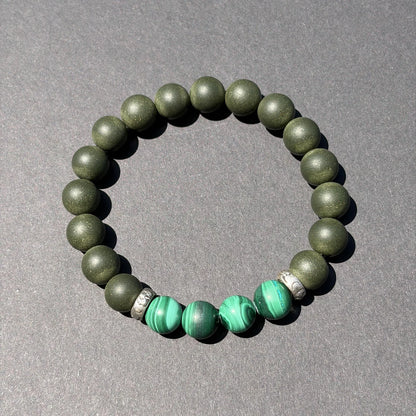 EAST PAVILION wearable incense bracelet shown from above with green accent beads.