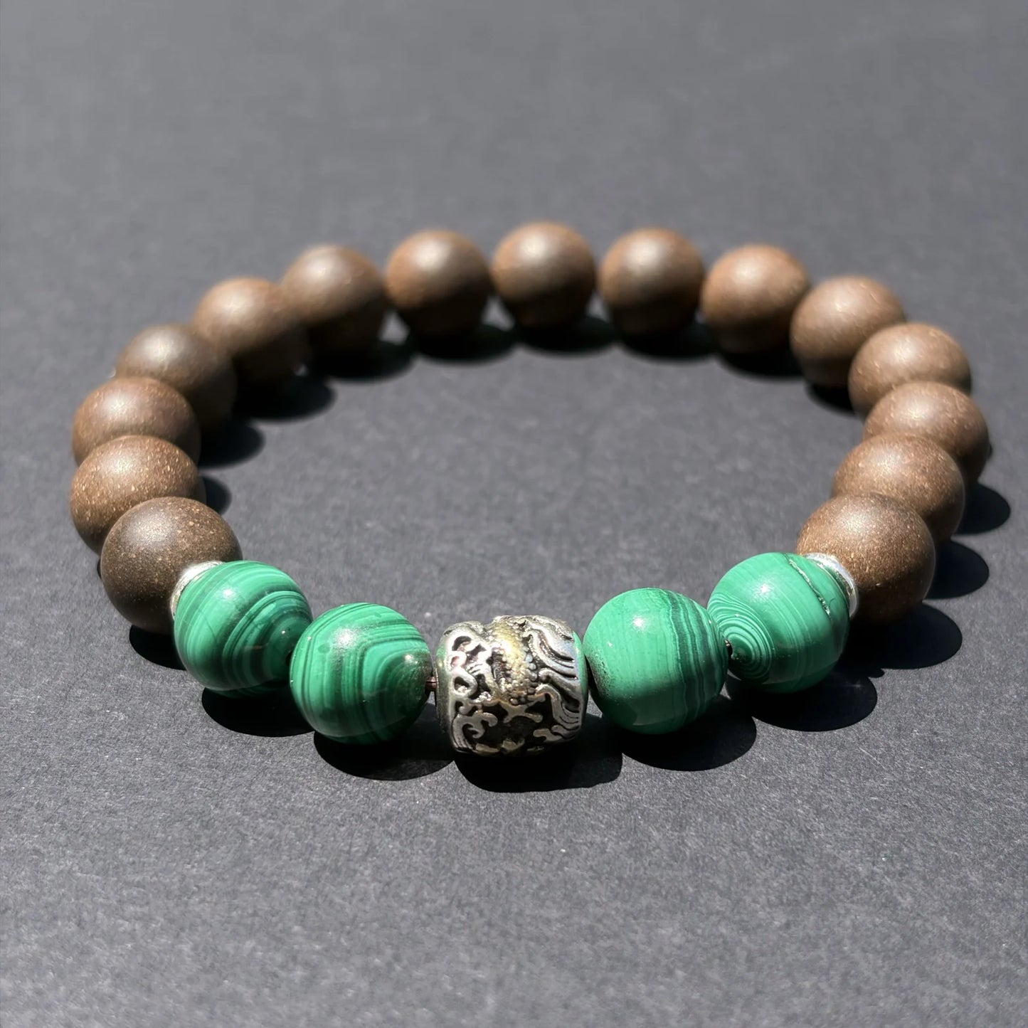 YONGZHENG COOL aromatic bead bracelet shown from an angled view on a clean gray surface.