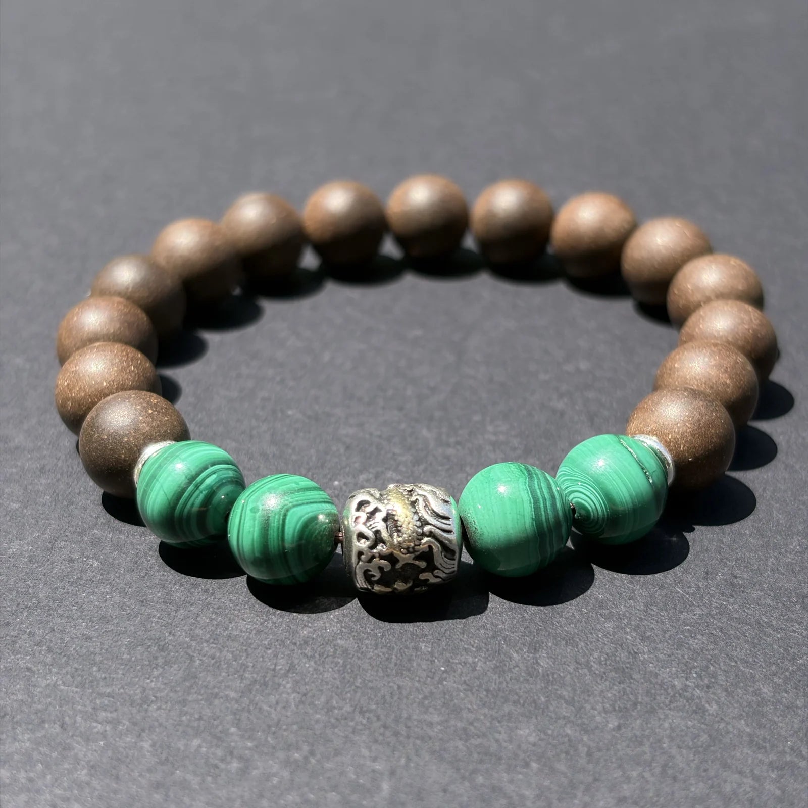 YONGZHENG COOL aromatic bead bracelet shown from an angled view on a clean gray surface.