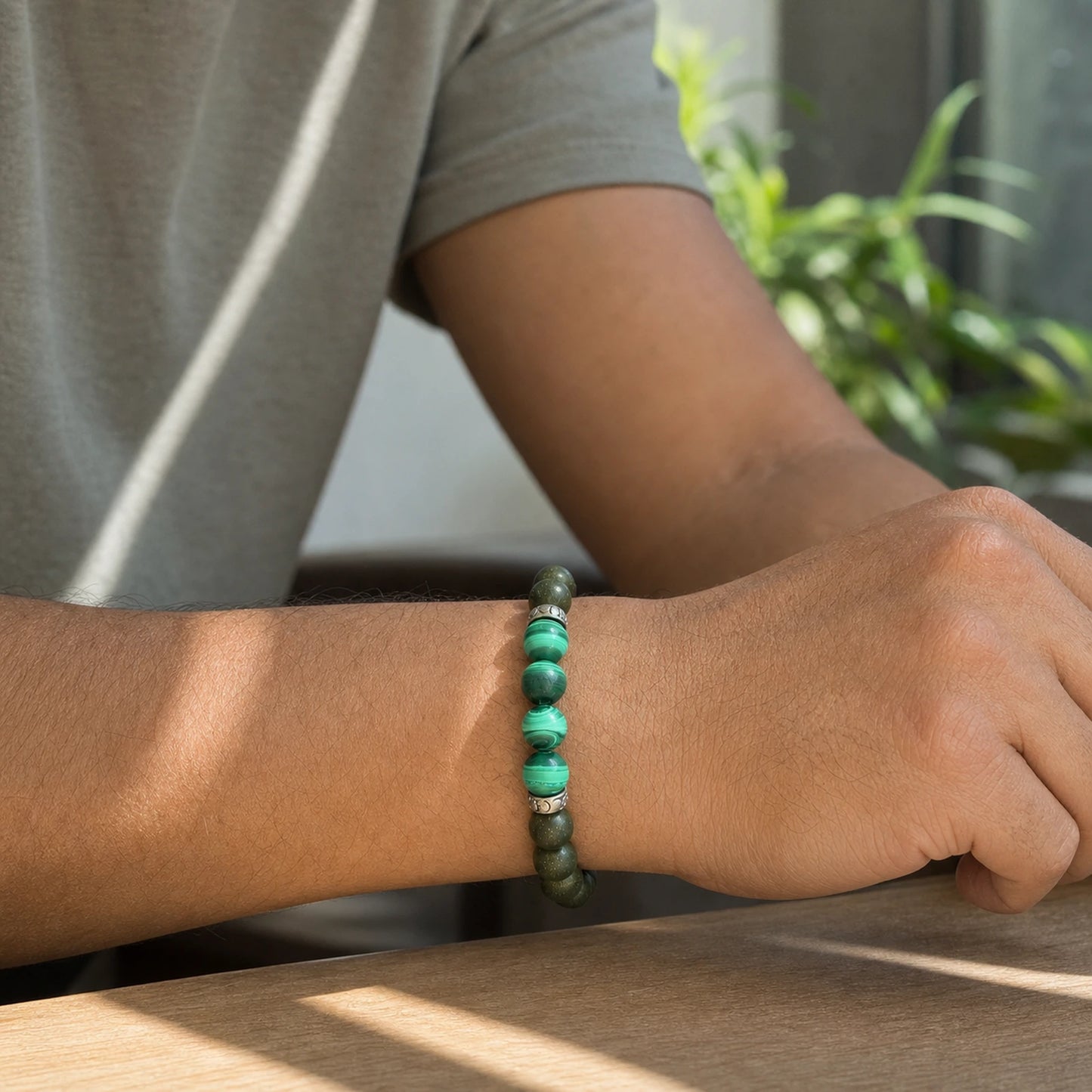 CENSEROOT East Pavilion wearable solid incense bracelet worn with a summer short-sleeve outfit, showing green focal beads and silver Pixiu-inspired spacer details.