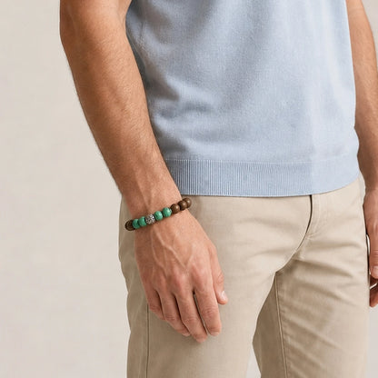 CENSEROOT Palace Breeze wearable solid incense bracelet worn with a light summer outfit, showing green malachite-style beads and a silver dragon spacer.